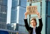 Young businessman holding sign Need Job outdoors